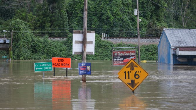 Signs are nearly submerged by floodwaters in Jackson, Kentucky.