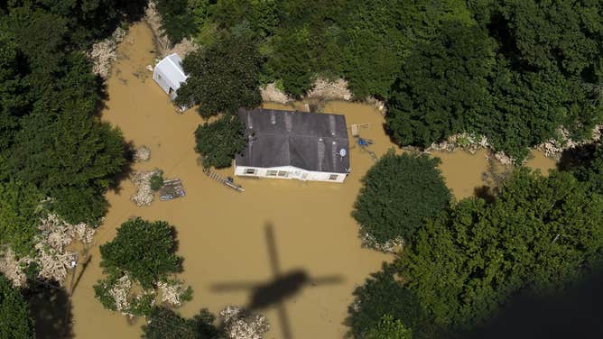 An aerial view of a home surrounded by floodwaters in Jackson, Kentucky.