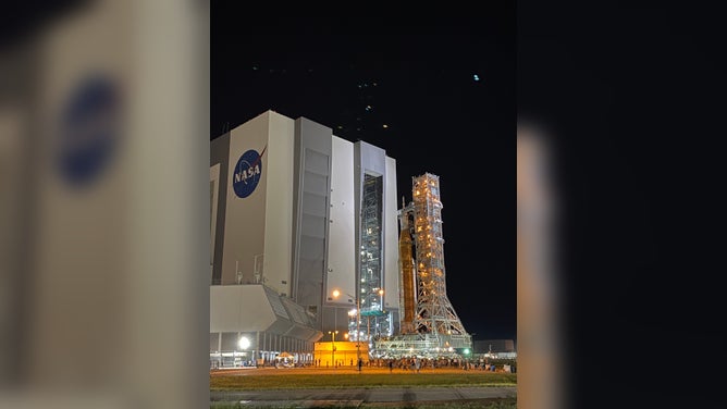 Spectators watch as NASA's SLS rocket and Orion spacecraft leave the Kennedy Space Center Vehicle Assembly Building on Aug. 16, 2022. The Artemis-1 rocket was moved to launchpad 39B ahead of the late August launch to the moon. (Image: Emilee Speck/FOX Weather)
