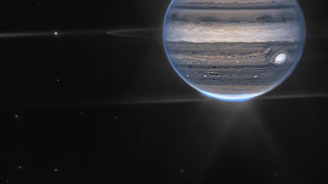 In this wide-field view, Webb sees Jupiter with its faint rings, which are a million times fainter than the planet, and two tiny moons called Amalthea and Adrastea. The fuzzy spots in the lower background are likely galaxies