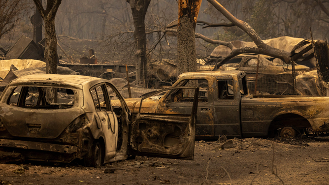 The ruins of the Oak Mobile Park are seen at the McKinney Fire in the Klamath National Forest northwest of Yreka, California, on July 31, 2022. - The largest fire in California this year is forcing thousands of people to evacuate as it destroys homes and rips through the state's dry terrain, whipped up by strong winds and lightning storms. The McKinney Fire was zero percent contained, CalFire said, spreading more than 51,000 acres near the city of Yreka.