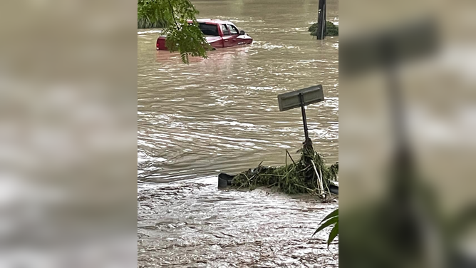 Flooding caused by heavy rainfall covers roads and vehicles in Kanawha County, West Virginia on Aug. 15, 2022.
