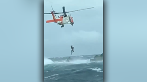 Man rescued from Earl's fury: Watch helicopter pull injured man off of rocks