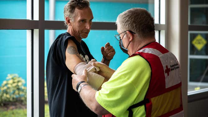 Red Cross volunteer Richard Dournink wraps up John Burrows' painful elbow at the Red Cross Evacuation Center in Clearwater, Fl.