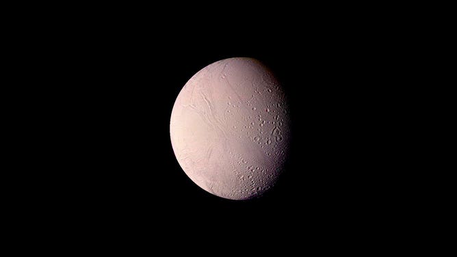 Saturn's moon Enceladus is 310 miles in diameter, as seen from 74,000 miles by Voyager on Aug. 25, 1982.