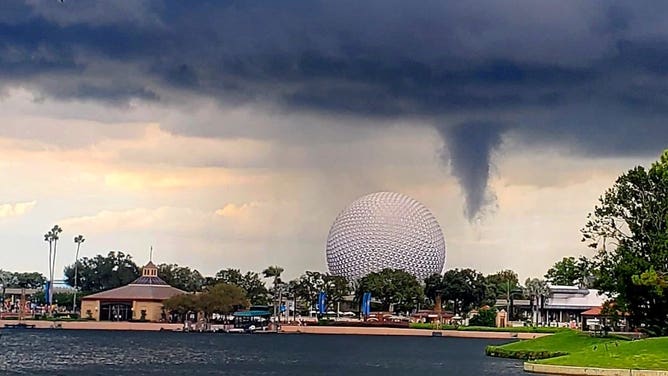 Dark skies and funnel cloud near Epcot's Spaceship Earth at Walt Disney World in Florida