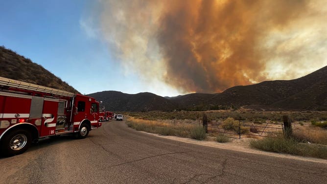 Orange-tinted smoke billows from the Fairview Fire in Riverside County, California.