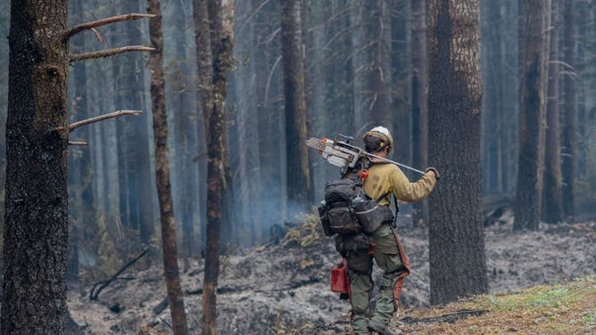 A hotshot firefighter works to contain the Cedar Creek fire just east of Oakridge, Oregon, on September 12, 2022.