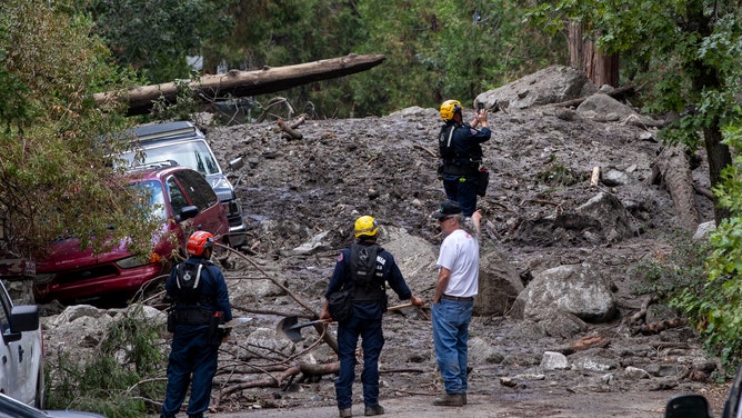 Mud and debris are piled high after heavy rains also triggered debris flows in Forest Falls, just a few miles away from Oak Glen, California.