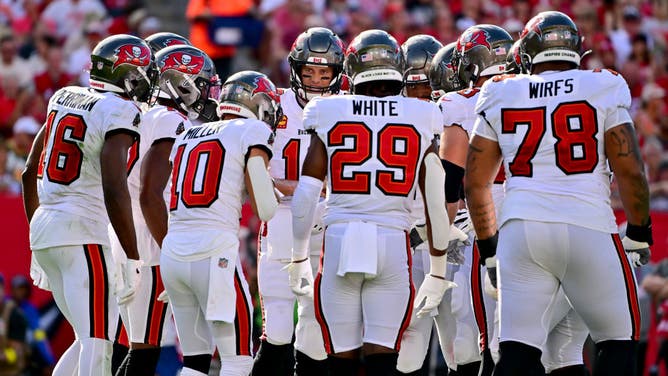 Tom Brady #12 of the Tampa Bay Buccaneers huddles with his team against the Green Bay Packers during the second quarter in the game at Raymond James Stadium on September 25, 2022 in Tampa, Florida.