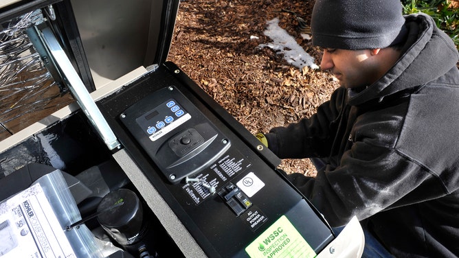 A.J. Juneja with Holt Electrical Service made adjustments to the generator being installed at a home on February 3, 2011 in Potomac, MD.