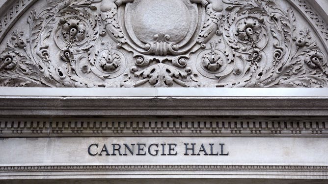 Architectural details on the exterior facade of Carnegie Hall, an historic concert venue on 7th Avenue in Midtown Manhattan in New York City.