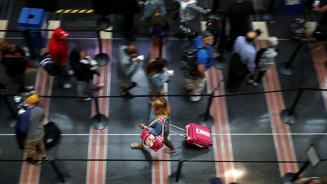 Travelers move through one of the Transportation Security Administration lines at Ronald Reagan National Airport.