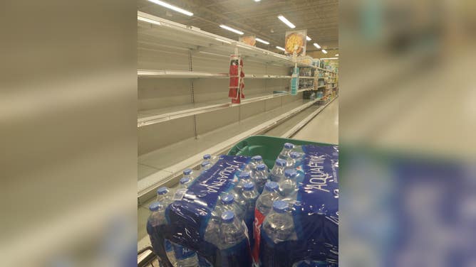 Empty shelves for bottled water at a Publix supermarket in Delray Beach, Florida