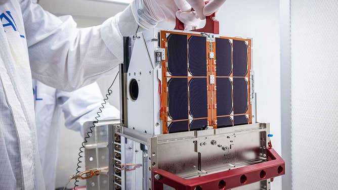 DART team engineers lift and inspect the LICIACube CubeSat after it arrived at Johns Hopkins APL in August 2021. The miniaturized satellite deploys 10 days before DART's asteroid impact.