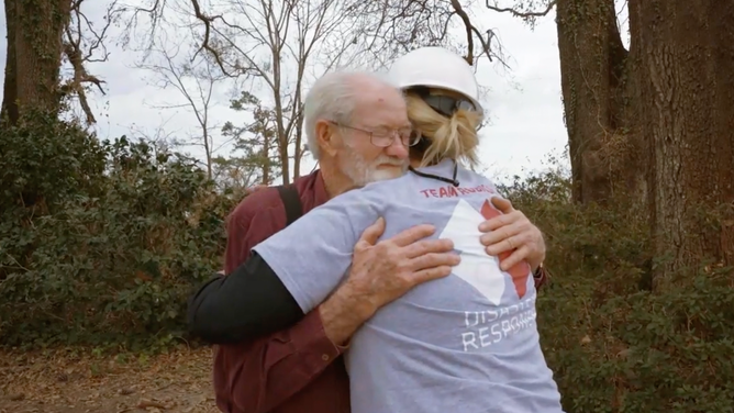 A Team Rubicon volunteer hugs a man who received help from Team Rubicon.