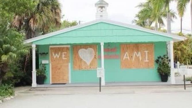 The words "We [heart] AMI" are spray painted onto boarded up windows in Anna Maria Island in Manatee County, Florida. "AMI" stands for Anna Maria Island.
