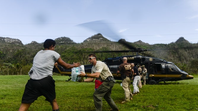 Homeland Security airlifting food and water to Utuado residents isolated after Hurricane Maria took out the bridge.