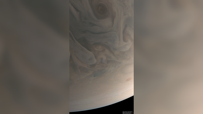 An image of Jupiter's clouds in gray tones processed to portray the approximate colors that the human eye would see from the Juno spacecraft's vantage point.