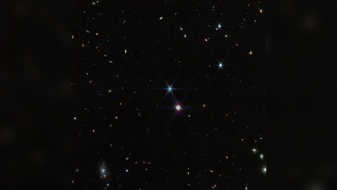 In this image by Webb’s Near-Infrared Camera (NIRCam), a smattering of hundreds of background galaxies, varying in size and shape, appear alongside the Neptune system. Neptune, when compared to Earth, is a big planet. If Earth were the size of a nickel, Neptune would be as big as a basketball. In most portraits, the outer planets of our solar system reflect this otherworldly size.