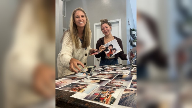 Fort Myers photographer Krista Kowalczyk looks through family photos damaged by Hurricane Ian. (Image credit: Impressions Photography)