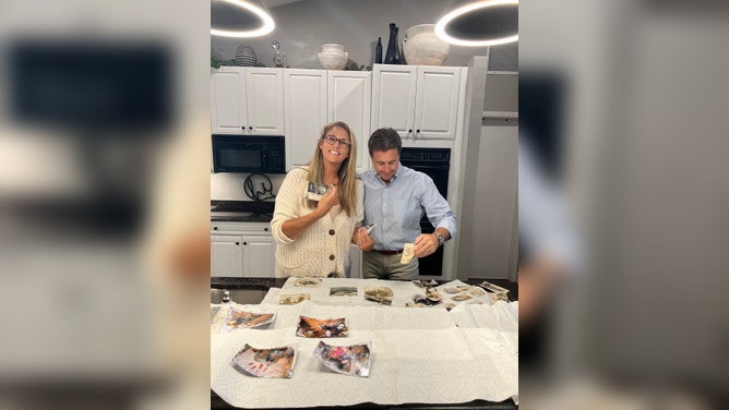 Fort Myers photographer Krista Kowalczyk looks through family photos damaged by Hurricane Ian.