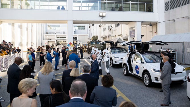 NASA astronaut Josh Cassada, left, NASA astronaut Nicole Mann, second from right, Roscosmos cosmonaut Anna Kikina, second from right, and Japan Aerospace Exploration Agency (JAXA) astronaut Koichi Wakata right, wearing SpaceX spacesuits, are seen as they prepare to depart the Neil A. Armstrong Operations and Checkout Building for Launch Complex 39A to board the SpaceX Crew Dragon spacecraft for the Crew-5 mission launch, Wednesday, Oct. 5, 2022, at NASA’s Kennedy Space Center in Florida