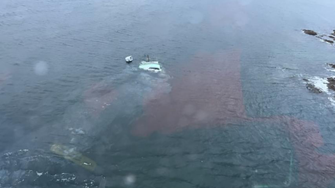 A sunken vessel is shown in Freshwater Bay, Alaska, after the vessel capsized with the owner and his two dogs aboard, Oct. 19, 2022. An Air Station Sitka aircrew rescued the man and his dogs from a nearby shore after he signaled the helo with a flare.