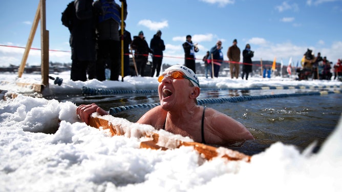 Louise Hyder-Darlington of Elizabethtown, PA reacts after finishing the 200 meter freestyle race at the annual Memphremagog Winter Swimming Festival in Newport, VT on Feb. 25, 2022.