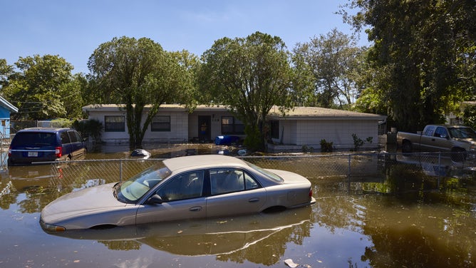 Homes and vehicles submerged in water in a flooded neighborhood following Hurricane Ian in Orlando, Florida, US, on Friday, Sept. 30, 2022. 