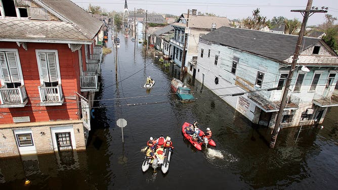 Search and rescue Teams head up Orleans St. in search of victims during the aftermath of Hurricane Katrina Saturday, September 3, 2005 in New Orleans, Louisiana.