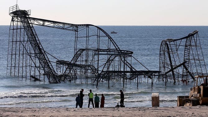 Workers prepare to remove the Star Jet roller coaster that has been in the ocean for six months after the Casino Pier is sat on collapsed when Superstorm Sandy hit, May 14, 2013 in Seaside Heights, New Jersey.