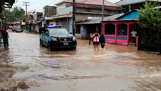 A police vehicle drives in a flooded street following the passage of Hurricane Julia in the town of Bluefields, on the Caribbean coast of Nicaragua on October 9, 2022. - Hurricane Julia raked across Nicaragua Sunday, lashing the country with winds and heavy rain and bringing potentially life-threatening flash flooding and mudslides to much of Central America.