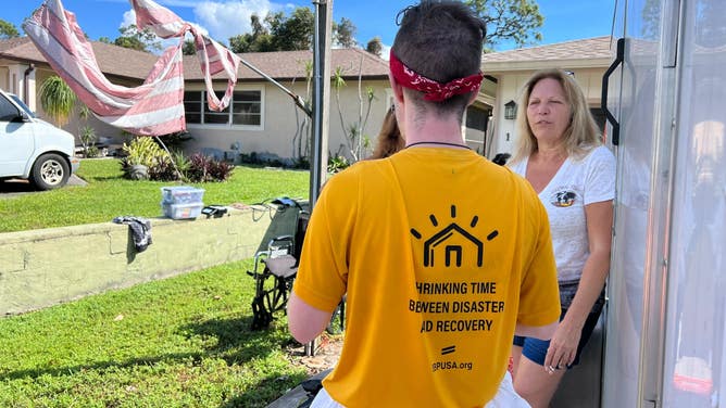 Heidi Schroyer speaks to a volunteer with St. Bernard Project.