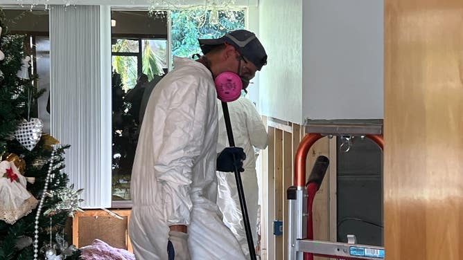 A volunteer with St. Bernard Project cleans a flood-damaged home.