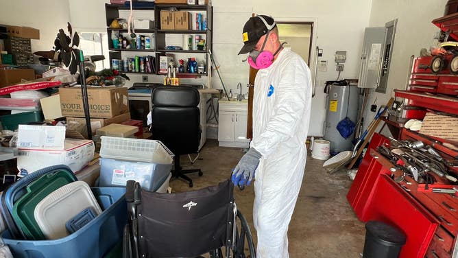 A volunteer with St. Bernard Project assesses items inside a home.