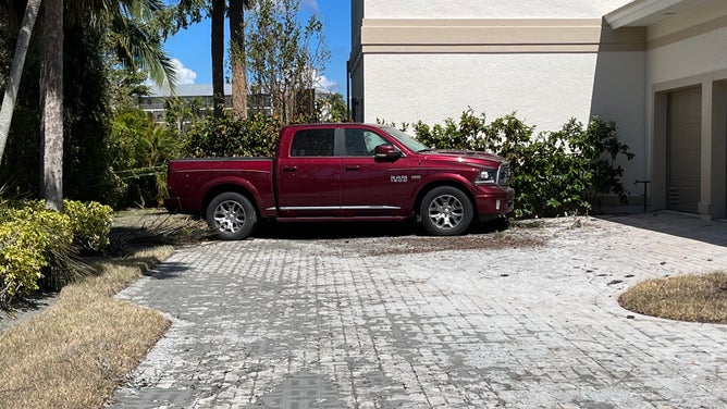 The Dodge Ram of Andrews's late husband was lifted by surge waters and turned 90 degrees toward her garage.