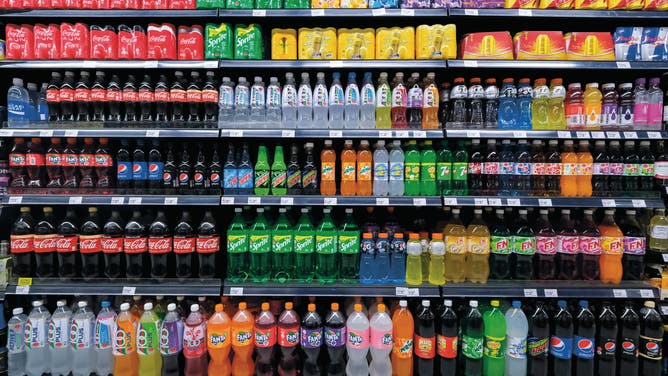 Variety of energy drinks, soda, soft drinks, with various brands product in bottles and cans on the shelves in a grocery store supermarket. Beverages industry.
