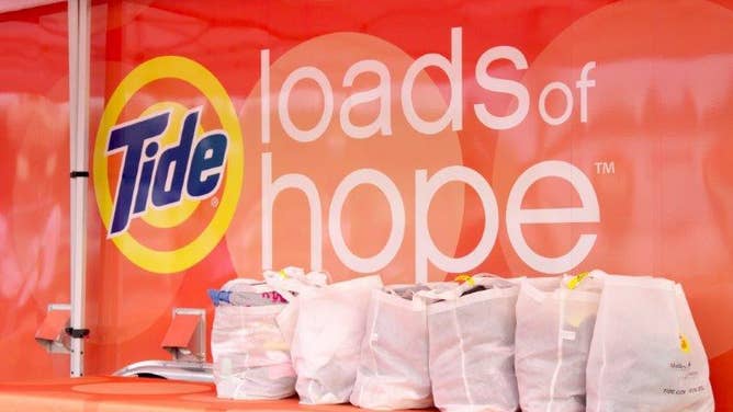 Bags of laundry being cleaned by Tide Loads of Hope.