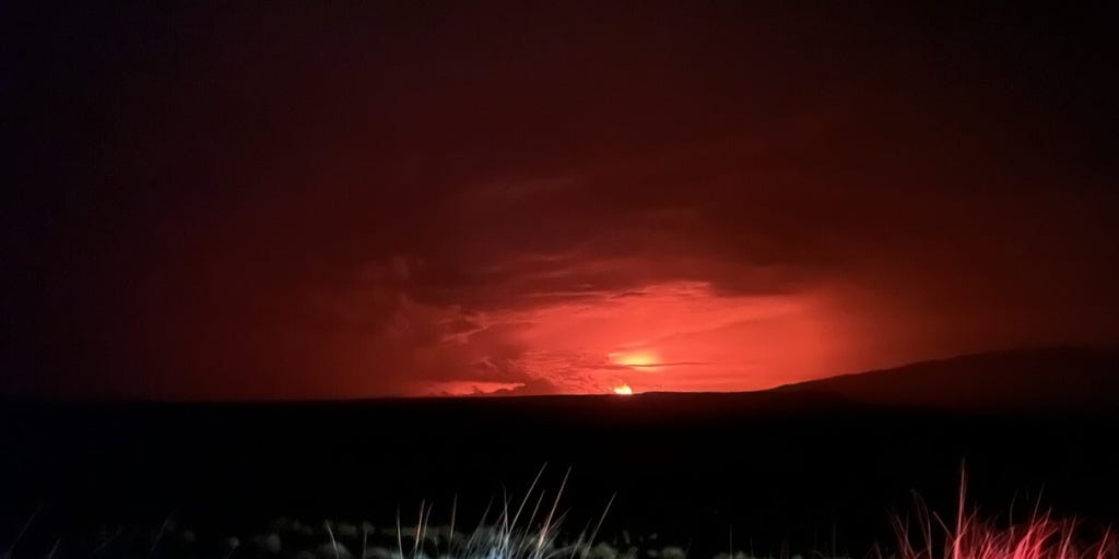 Lava flows from Mauna Loa volcano create glowing sky across Hawaii's
