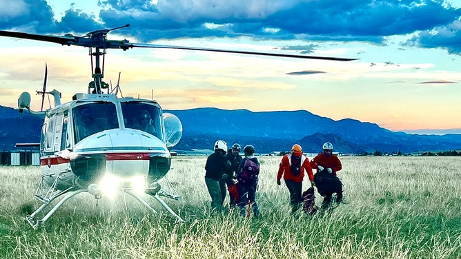 Crew near a helicopter.