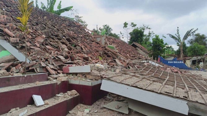 A collapsed building is seen after a magnitude 5.6 earthquake in Cianjur, Indonesia.