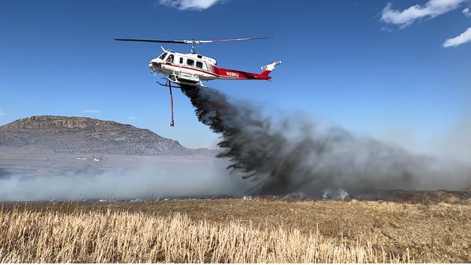 A helicopter taking out a fire.