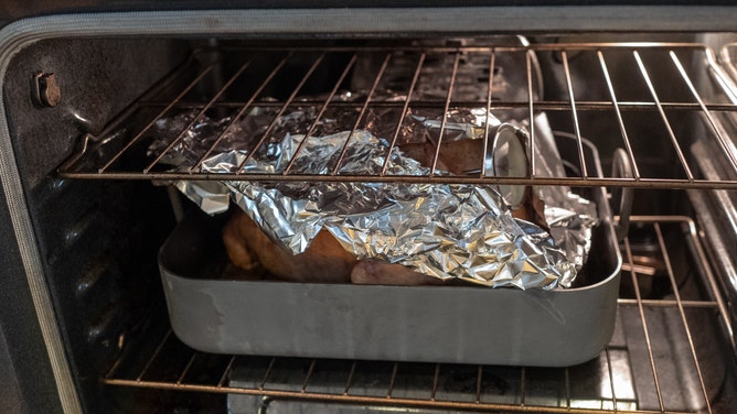 Tented turkey in oven.