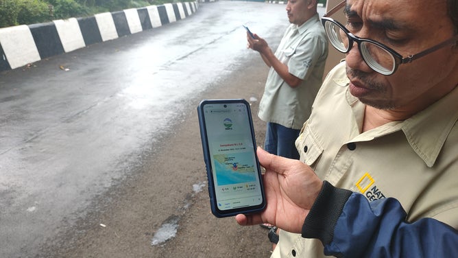 Employees gather outside a office in Bogor, West Java, Indonesia on November 21, 2022, shortly after a 5.6-magnitude earthquake struck off Cianjur Regency, West Java.
