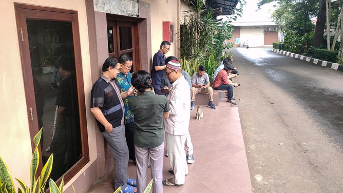 Employees gather outside a office in Bogor, West Java, Indonesia on November 21, 2022, shortly after a 5.6-magnitude earthquake struck off Cianjur Regency, West Java.