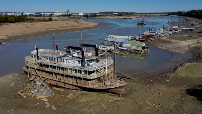 MEMPHIS, TENNESSEE - OCTOBER 19: The Diamond Lady, a once majestic riverboat, rests with smaller boats in mud at Riverside Park Marina in Martin Luther King Jr. Riverside Park along the Mississippi River on October 19, 2022 in Memphis, Tennessee. Lack of rain in the Ohio River Valley and along the Upper Mississippi has the Mississippi River south of the confluence of the Ohio River nearing record low levels which is wreaking havoc at marinas, and with barge traffic, driving up shipping prices and threatening crop exports and fertilizer shipments as the soybean and corn harvest gets into full swing.