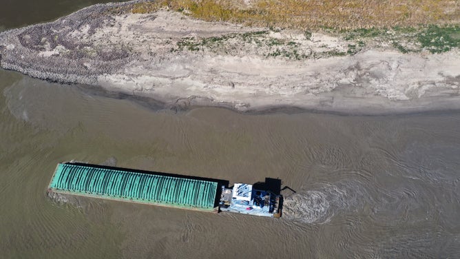 GREENVILLE, MISSISSIPPI - OCTOBER 20: In this aerial view, a tug pushes a barge into the Mississippi River from the Port of Greenville on October 20, 2022 near Greenville, Mississippi. Lack of rain in the Ohio River Valley and along the Upper Mississippi has the Mississippi River south of the confluence of the Ohio River nearing record low levels which is wreaking havoc with barge traffic, driving up shipping prices and threatening crop exports and fertilizer shipments as the soybean and corn harvest gets into full swing.
