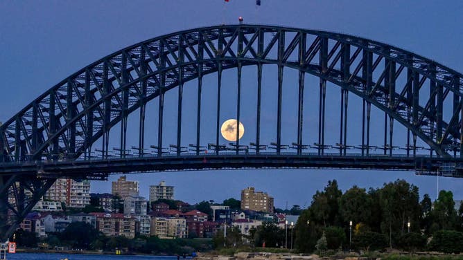 Full moon is seen through the Sydney Harbour bridge on November 08, 2022 in Sydney, Australia. Australians will experience the first visible total lunar eclipse of the year on Tuesday, the ABC reported, with the eclipse also being visible from New Zealand. The (Photo by Saverio Marfia/Getty Images)