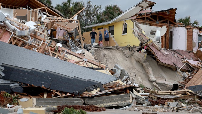 Several damaged homes dangle precariously along washed out Florida ...